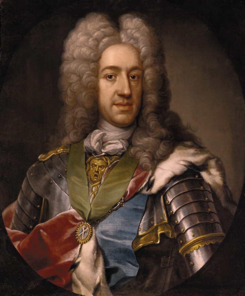Oil on canvas of a royal portrait of a king. He has a shoulder length grey powdered wig. He is wearing armour with a ermine trimmed cloak over his shoulders