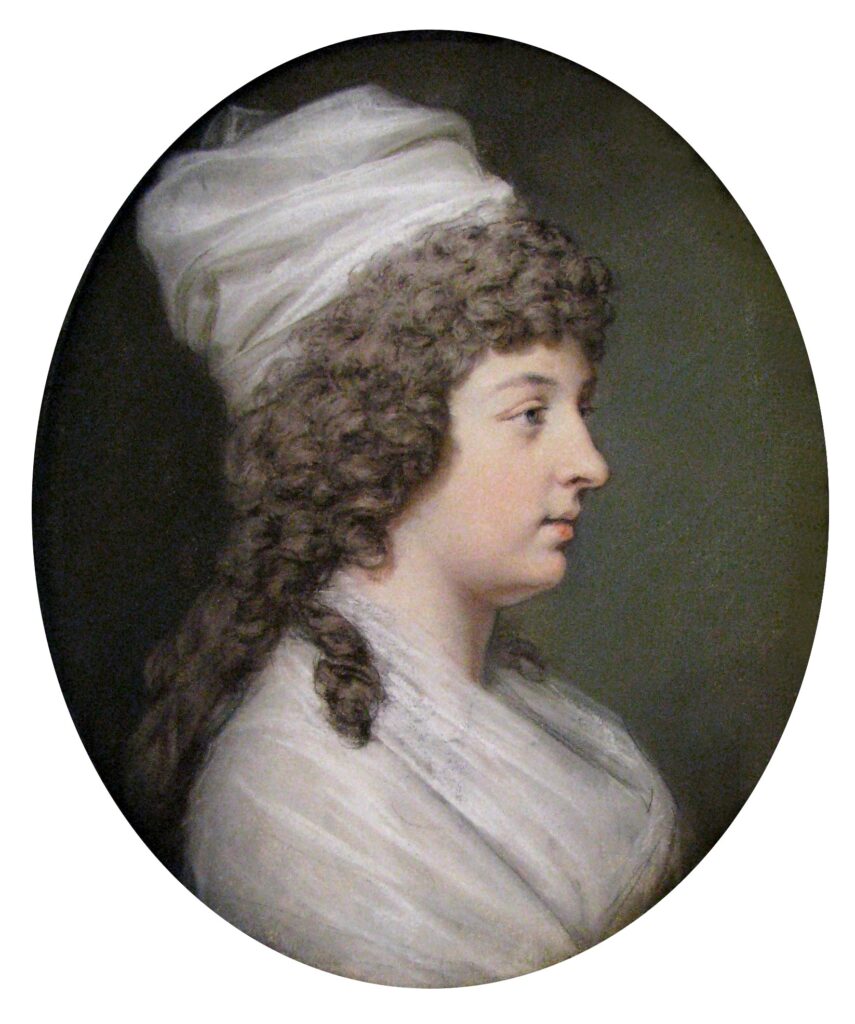 oil portrait of a lady with grey long curly hair and a whjte cap. Wearing a white dress/shawl