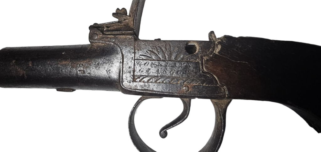 Close up photograph of the trigger and metal engraved metalwork above the trigger. Shows the maker's mark and reads "Gourlay Glasgow"