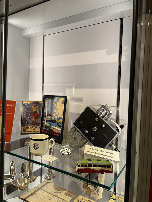 A bus ticket collecting machine, mug and other High Street related objects